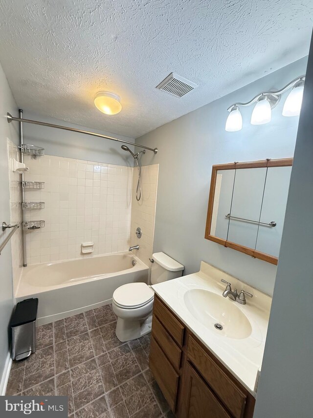 bathroom featuring a textured ceiling, visible vents, vanity, toilet, and tub / shower combination