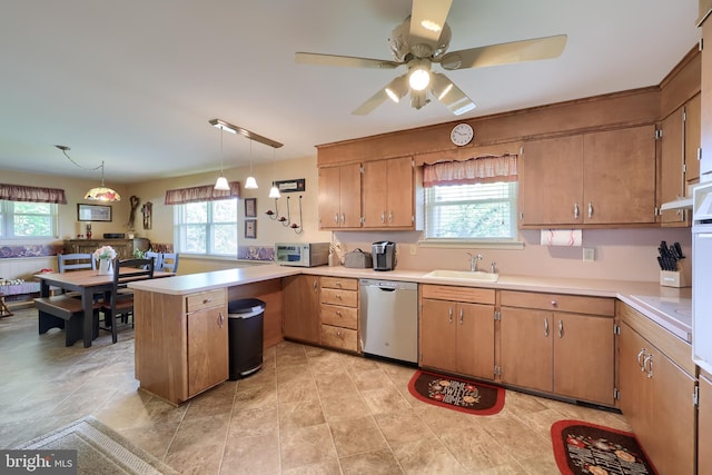 kitchen with a sink, a peninsula, a healthy amount of sunlight, and white appliances