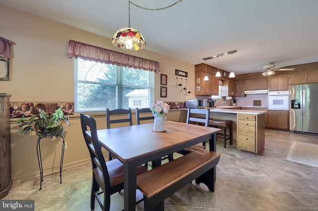 dining space with a ceiling fan