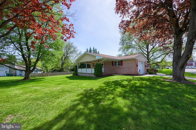 view of side of property featuring a lawn, brick siding, fence, and a garage