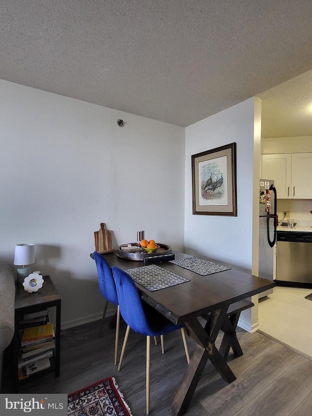 2020 Walnut St Unit 21K, Philadelphia, PA 19103 - dining room featuring baseboards, a textured ceiling, and wood finished floors