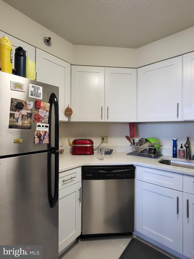 2020 Walnut St Unit 21K, Philadelphia, PA 19103 - kitchen featuring light countertops, a sink, white cabinets, and stainless steel appliances
