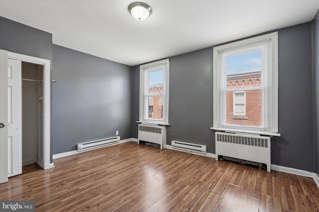 2062 E Stella St, Philadelphia, PA 19134 - unfurnished bedroom with wood finished floors, a baseboard radiator, and radiator heating unit