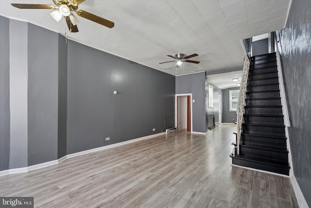 2062 E Stella St, Philadelphia, PA 19134 - unfurnished living room with baseboards, a ceiling fan, stairs, and wood finished floors