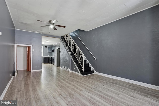 2062 E Stella St, Philadelphia, PA 19134 - unfurnished living room featuring stairs, a ceiling fan, baseboards, wood finished floors, and a baseboard heating unit