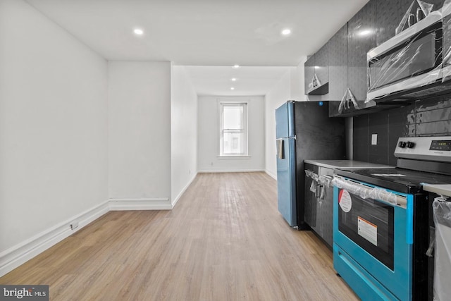 kitchen with tasteful backsplash, baseboards, light wood-style floors, stainless steel appliances, and recessed lighting