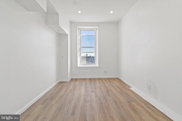 unfurnished room with baseboards, recessed lighting, and wood finished floors