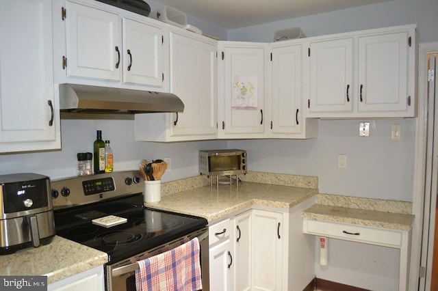 1837 Watson Rd, Abington, PA 19001 - kitchen with under cabinet range hood, light countertops, stainless steel electric range oven, and white cabinetry