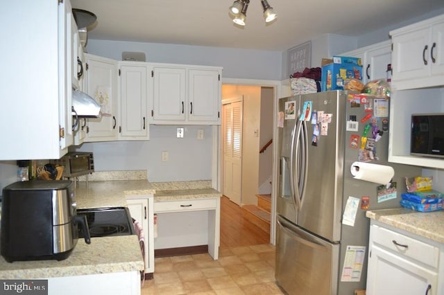 1837 Watson Rd, Abington, PA 19001 - kitchen featuring stainless steel fridge, light floors, white cabinetry, light countertops, and black microwave