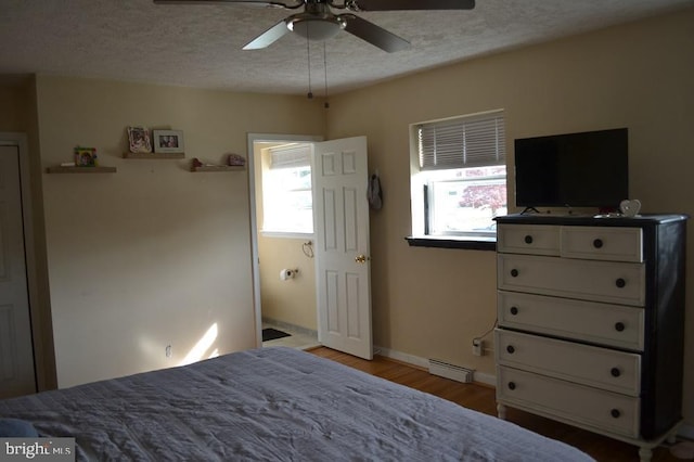 1837 Watson Rd, Abington, PA 19001 - bedroom with a baseboard heating unit, a textured ceiling, a ceiling fan, baseboards, and light wood-style floors