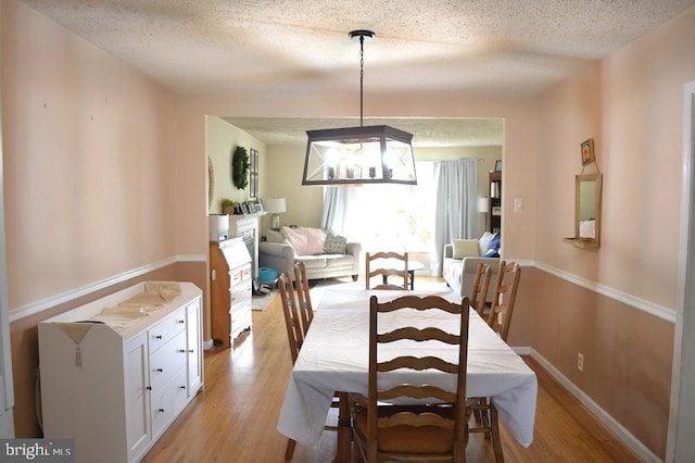 1837 Watson Rd, Abington, PA 19001 - dining space featuring an inviting chandelier, a textured ceiling, baseboards, and light wood-type flooring