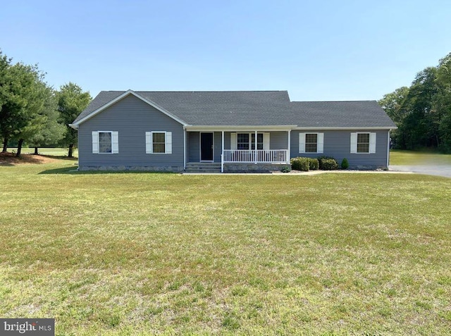 ranch-style home featuring a porch, a front lawn, and roof with shingles