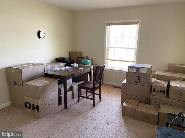 carpeted home office with baseboards