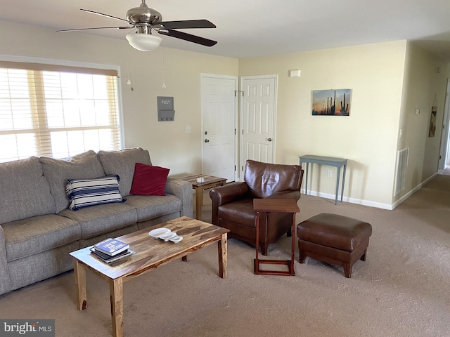 living area with carpet floors, a ceiling fan, baseboards, and visible vents