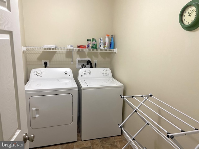 32569 Mount Pleasant Rd, Laurel, DE 19956 - clothes washing area featuring washing machine and clothes dryer, laundry area, and stone finish floor