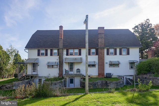 104 N Custer Ave, New Holland, PA 17557 - rear view of house with a yard, a chimney, and central air condition unit