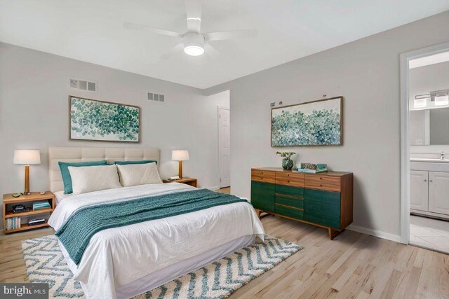 bedroom featuring visible vents, light wood finished floors, and baseboards
