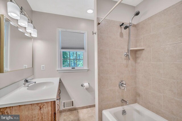 full bath with tile patterned flooring, vanity, baseboards, shower / bathing tub combination, and visible vents