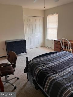 bedroom with carpet and a closet