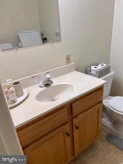 bathroom with vanity, tile patterned floors, and toilet