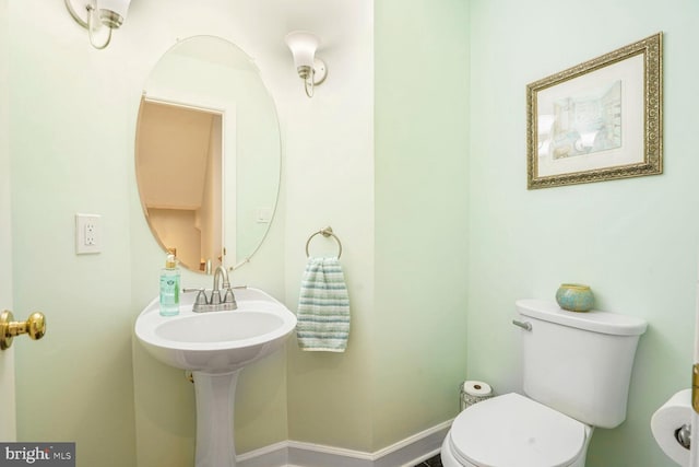 half bathroom featuring toilet