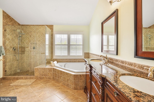 full bath with tile patterned floors, a bath, a shower stall, and a sink