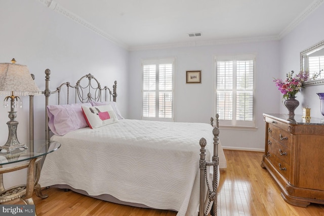 bedroom featuring multiple windows and light wood-style flooring