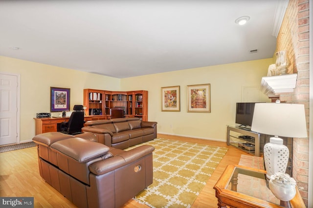 living area featuring light wood-style flooring, baseboards, and visible vents