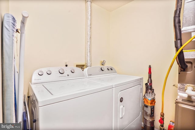 clothes washing area with laundry area and washer and clothes dryer