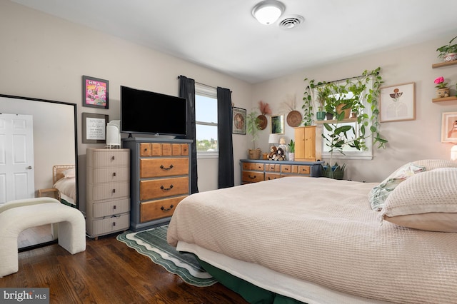 bedroom with visible vents and dark wood-style floors