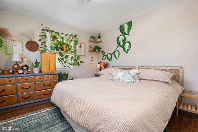 bedroom with dark wood finished floors