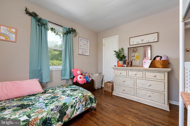 bedroom with dark wood finished floors