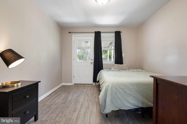 bedroom with baseboards and light wood-style flooring