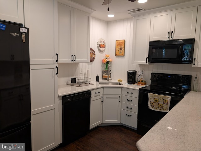 kitchen featuring ceiling fan, visible vents, a sink, white cabinets, and black appliances