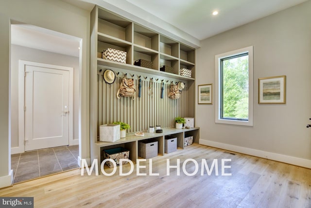 mudroom with baseboards, recessed lighting, and wood finished floors