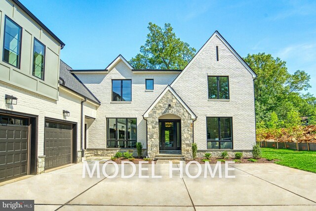 view of front of house with brick siding, driveway, and stone siding