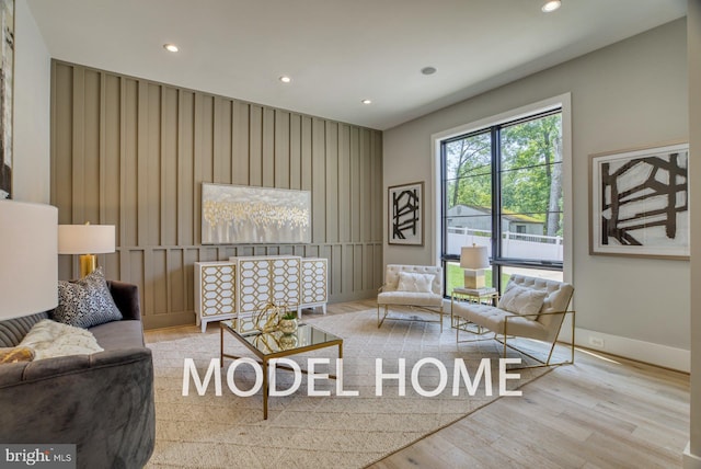 living room with recessed lighting, baseboards, and wood finished floors
