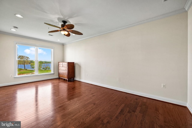 unfurnished room with ceiling fan, dark wood-style floors, ornamental molding, and baseboards
