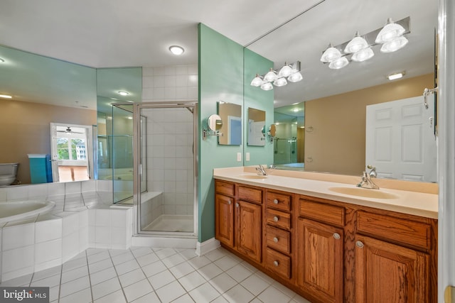 bathroom with a shower stall, a sink, and tile patterned flooring