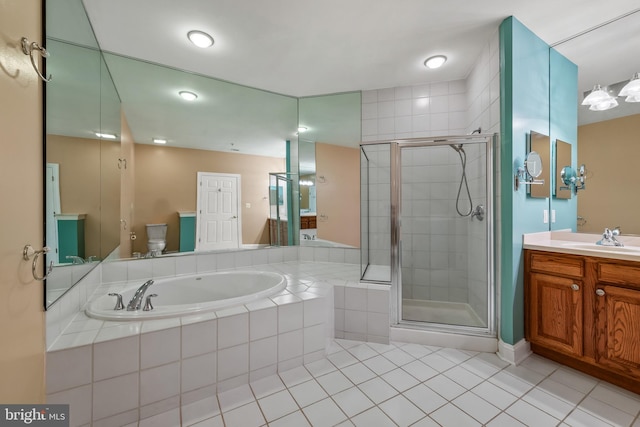full bathroom featuring tile patterned flooring, a shower stall, a bath, and vanity