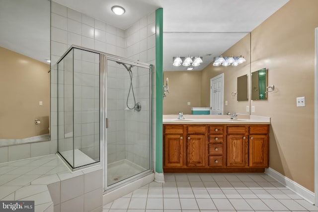 full bathroom with tile patterned flooring, a sink, and a shower stall