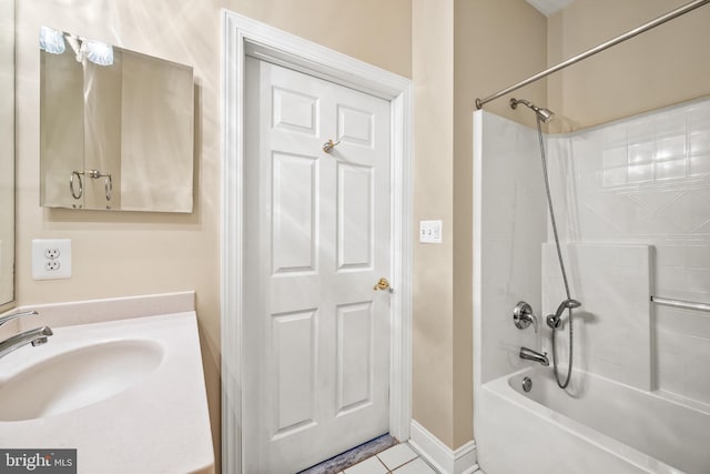 full bathroom featuring tile patterned flooring, baseboards, bathing tub / shower combination, and vanity
