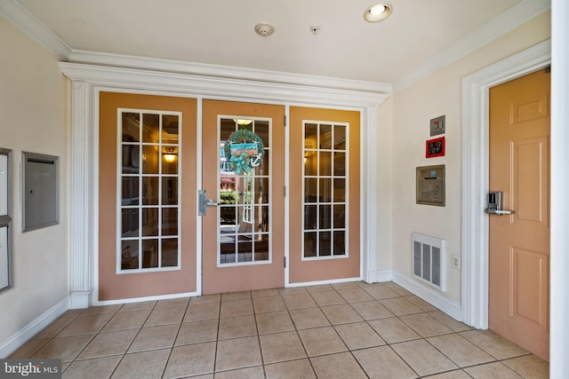 entryway featuring light tile patterned flooring, visible vents, and ornamental molding