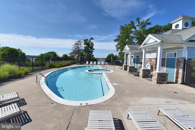 community pool featuring fence and a patio area