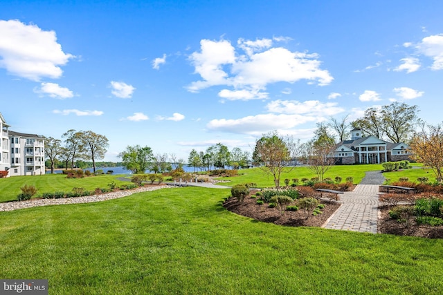 view of home's community featuring a water view and a yard