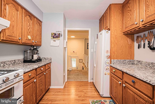 11039 Timberview Dr, Manassas, VA 20111 - kitchen with white appliances, brown cabinets, light wood-type flooring, and light stone countertops