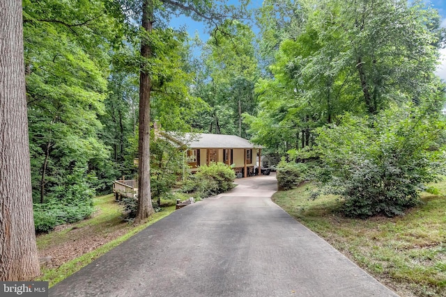 11039 Timberview Dr, Manassas, VA 20111 - view of front facade with driveway, brick siding, and a wooded view