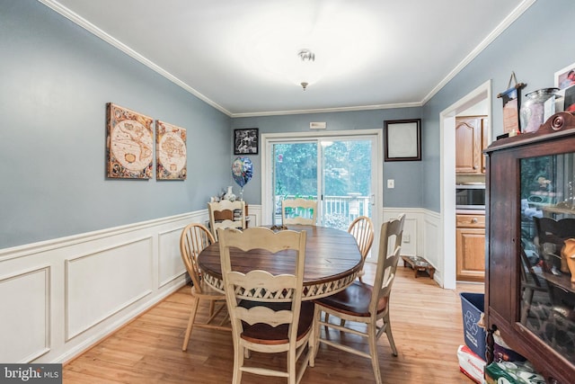 11039 Timberview Dr, Manassas, VA 20111 - dining space featuring light wood finished floors, a decorative wall, a wainscoted wall, and ornamental molding