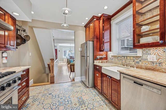 2410 S Camac St, Philadelphia, PA 19148 - kitchen with light stone counters, a sink, appliances with stainless steel finishes, backsplash, and hanging light fixtures