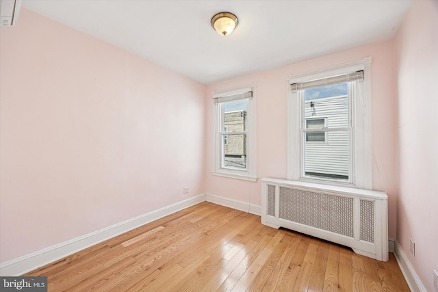 2410 S Camac St, Philadelphia, PA 19148 - spare room with hardwood / wood-style flooring, baseboards, and radiator
